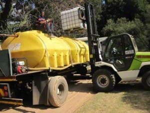 Forklift being used to load EBS into water tanker