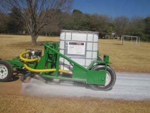 Using a trailer with pump and spray bar to apply EBS surface seal
