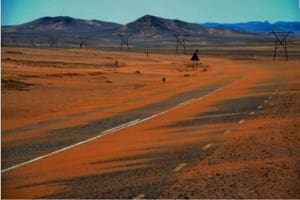 desert sand blowing over road